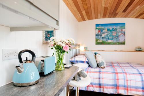 a bedroom with a bed and a counter with a blue kettle at Mount View Overnight Accommodation in Penzance