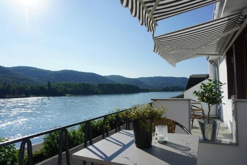 a balcony with a view of the river at Leutesdorfer Hof in Leutesdorf