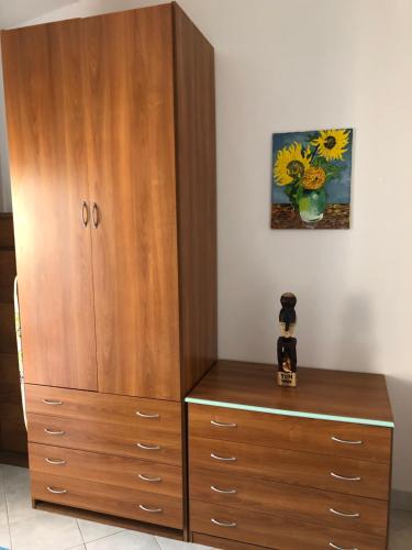 a large wooden cabinet with a dresser in a room at House Turi in Ardea