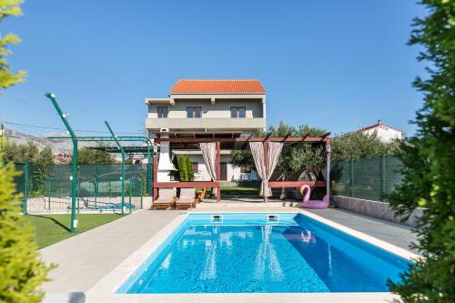 a villa with a swimming pool and a house at Villa Fay Split in Split