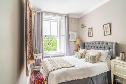 a bedroom with a bed and a window at House close to kings cross in London
