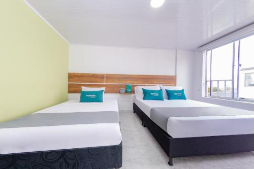 Säng eller sängar i ett rum på Casa Mama Hotel