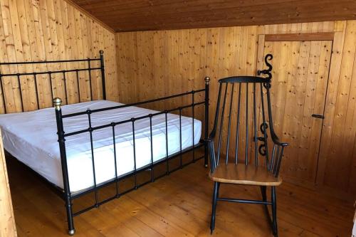 a bedroom with a bed and a chair and a door at Familien-Haus,Garten,Grill,20m zum Rhein in Stein am Rhein
