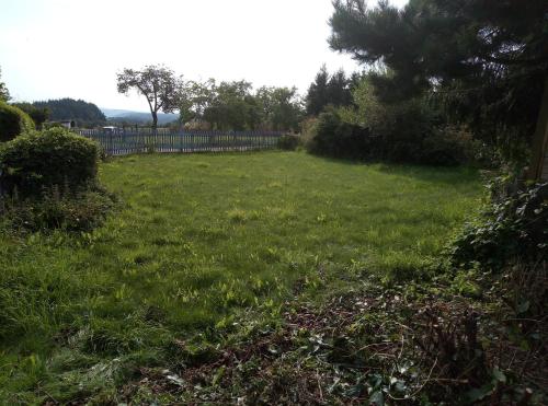 a yard with a fence and a field of grass at My Home is my Castle in Hontheim