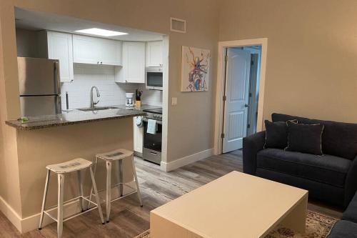a living room with a couch and a kitchen at Siesta Key Village-Suite #4: A block to the Beach! in Sarasota