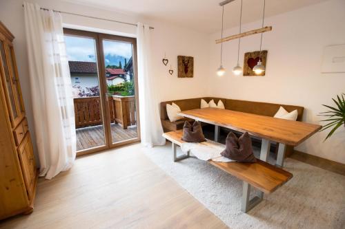a living room with a wooden table and a couch at Ferienwohnung Lorenz in Ruhpolding