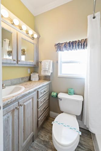 a bathroom with a toilet and a sink at Sun Outdoors Sarasota in North Sarasota