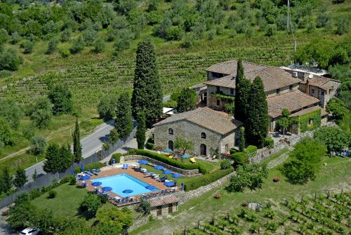 a house with a pool and trees at Hotel Belvedere Di San Leonino in Castellina in Chianti