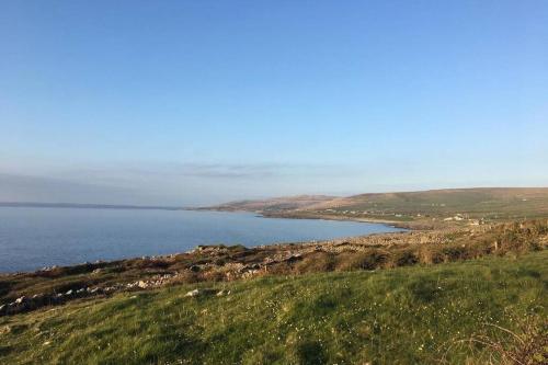 a view of a large body of water on a hill at Apartment on Wild Atlantic Way in Fanore