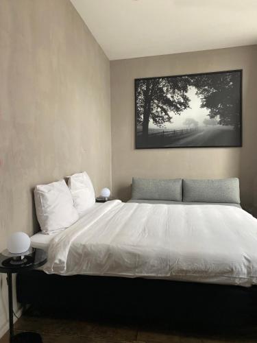 a bedroom with a bed with a picture on the wall at Loft O - River View in Antwerp