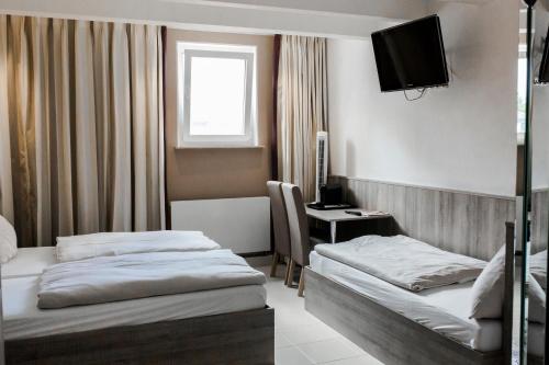 Ένα ή περισσότερα κρεβάτια σε δωμάτιο στο Bach Hotel