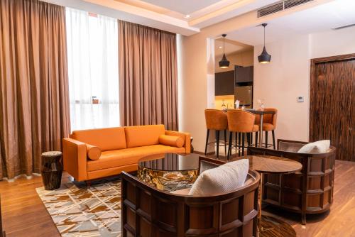 a living room with a couch and a table at Hôtel Fleur de Lys Point E in Dakar