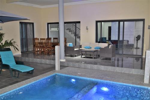 Ngaparou的住宿－Villa Moderne Spacieuse avec Piscine Privée, 3Ch et 3SdB，一座带游泳池和客厅的房子
