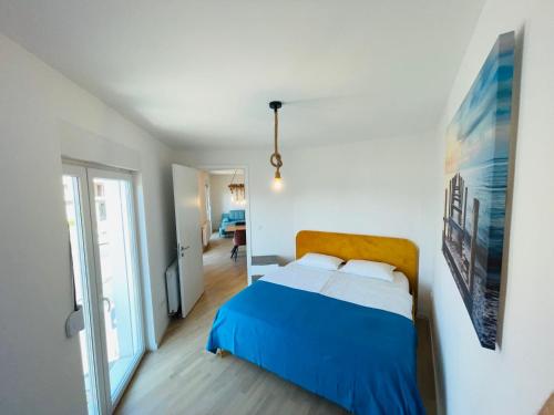 a bedroom with a blue and white bed in a room at Apartment 7 in Sarajevo