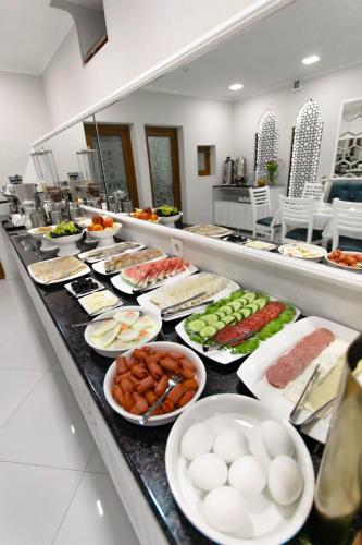 a buffet line with many different types of food at Registon Saroy Hotel in Samarkand