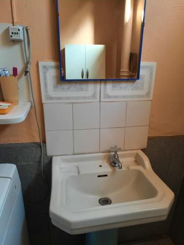 a bathroom with a white sink and a mirror at Victor-alojamientos in La Serena