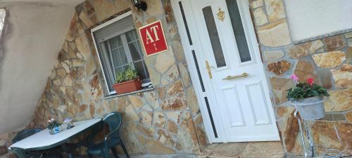 a stone building with a door and a sink and a window at Apartamentos Casa Alvarina - Luarca in Cortina