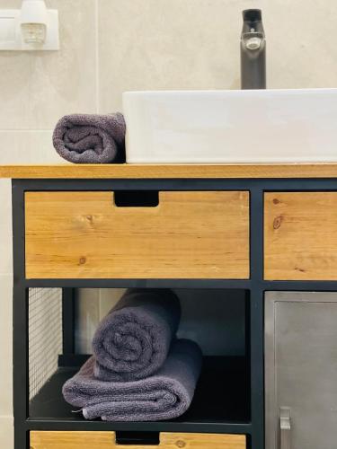a bathroom counter with towels and a sink at Villa 112 in Dîrlos