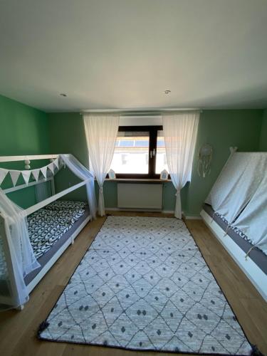 a bedroom with two bunk beds and a rug at Ferienhaus mit Blick ins Grüne in Contwig