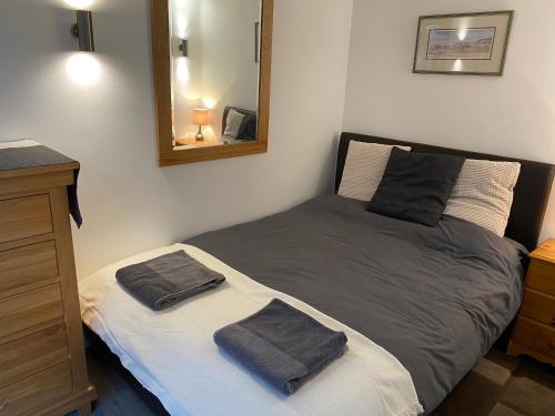 a bedroom with a bed with two towels on it at Delightful 1 bedroom chalet in Throwleigh