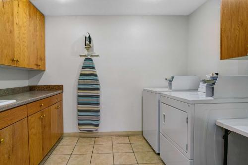 a kitchen with a washer and dryer on the wall at Motel 6-Idaho Falls, ID - Snake River in Idaho Falls