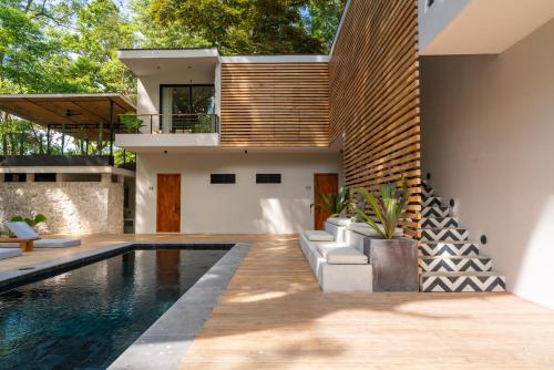 a home with a swimming pool and a house at Nala Luxury Living - Santa Teresa - Costa Rica in Santa Teresa Beach