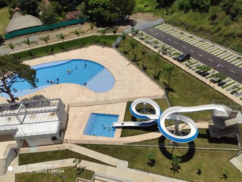 an overhead view of a swimming pool with a sculpture next to it at Apartasol Citadela Di Sole 1104 - Santafé de Antioquia in Santa Fe de Antioquia