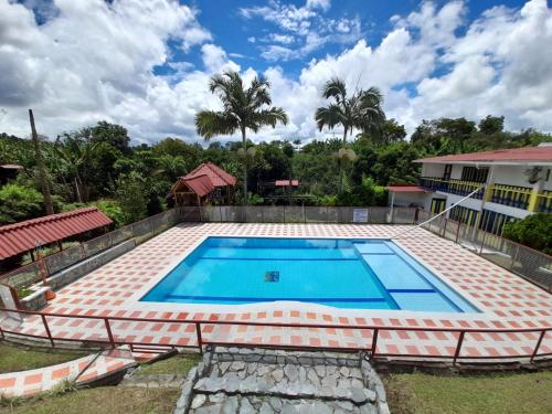 a large swimming pool in the backyard of a house at Chalet Villa Alejandra Del Pilar in Quimbaya