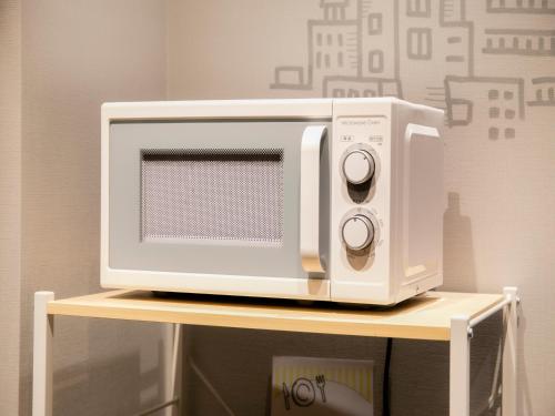 a microwave oven sitting on top of a table at Hotel Wing International Ikebukuro in Tokyo