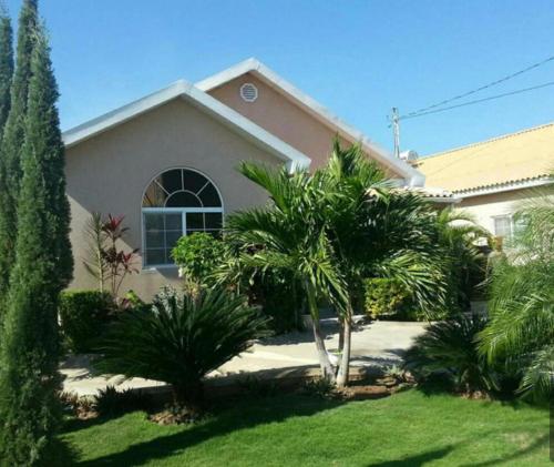 a house with palm trees in front of a yard at Luxurious Secret Escape in Portmore