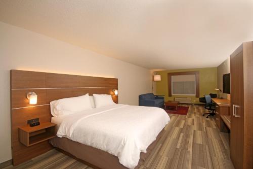 a hotel room with a large bed and a desk at Holiday Inn Express Troutville-Roanoke North by IHG in Troutville
