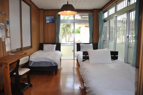 מיטה או מיטות בחדר ב-Accommodation Limited to One Group Per Day Yukuiru