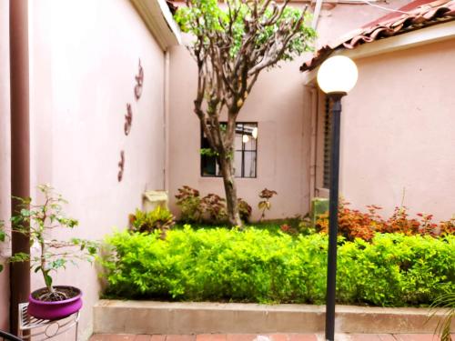a street light in front of a house with plants at Hotel Brunette in Santa Ana