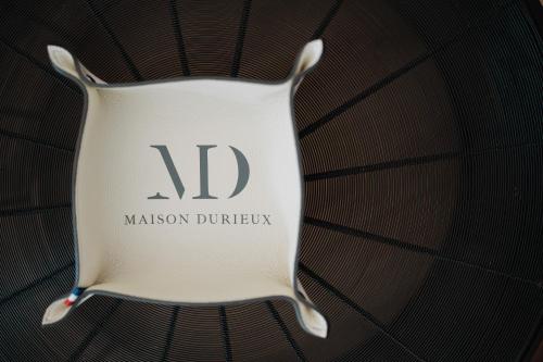 a white plate with the word malcolm duriston on it at Maison Durieux in Limoges