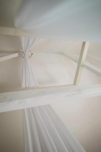 a white ceiling with white curtains on it at Maison Durieux in Limoges