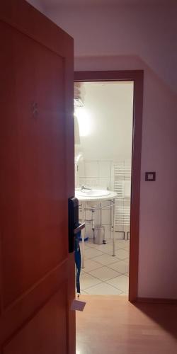 a cat standing on a door in a room at Pansion Danica in Rastovača
