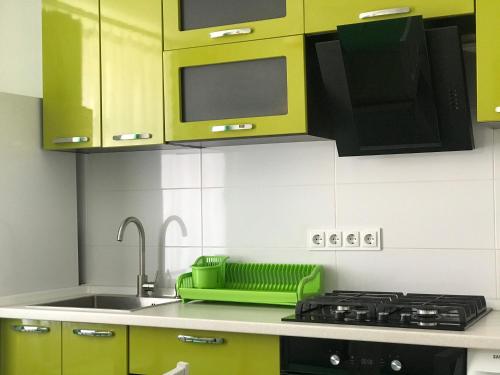 a kitchen with lime green cabinets and a sink at MaryLu home in Lviv