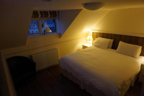 a bedroom with a large white bed with two pillows at The Fleet Inn in Killybegs