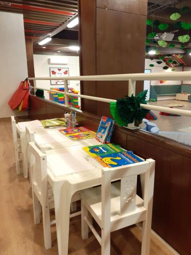 a white table with white chairs in a store at Family Resort Urania in Baška Voda
