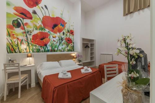 a bedroom with two beds and a painting of flowers at Hotel Mimosa Pantheon in Rome