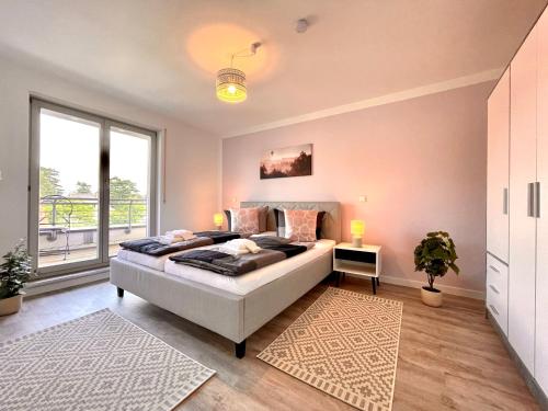 a bedroom with a bed and a large window at Apartment Rooftop in Dresden
