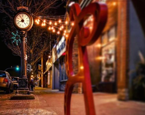 a pair of scissors sitting on a sidewalk next to a clock at Holiday Inn Express & Suites - Saskatoon East - University by IHG in Saskatoon