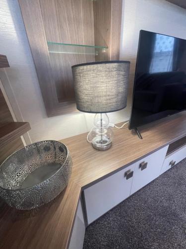 a bathroom with a sink and a television on a counter at Luxury Static Home 2 Bed Sleeps 6 in Great Yarmouth