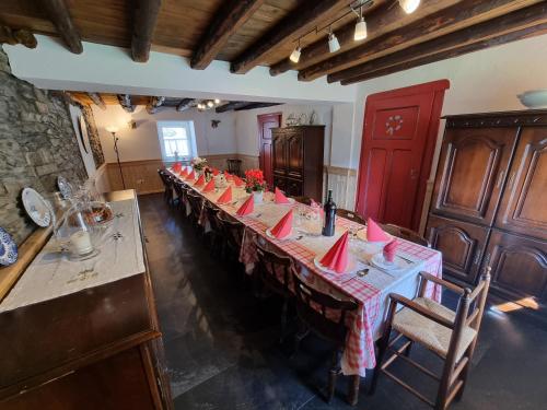 a long table with red napkins on it in a room at Sneeuweifel in Burg-Reuland