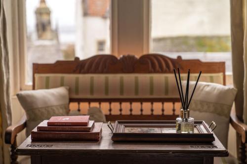 a table with books and chopsticks on top of it at stay bed and breakfast in Culross