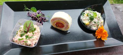 a tray with three different types of food on it at Pension Elegance in Gura Humorului
