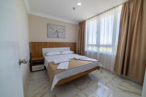 Postel nebo postele na pokoji v ubytování REGA OTEL