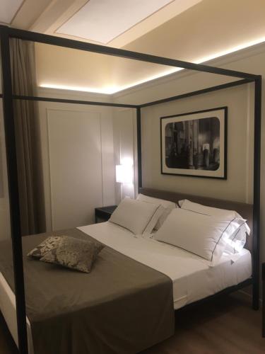 a bedroom with a large bed with a black frame at La Bella Modena Centro in Modena