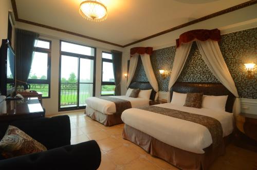 a hotel room with two beds and a balcony at Full Sweet Inn in Wujie