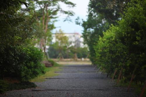 a road with trees and a building in the distance at Full Sweet Inn in Wujie